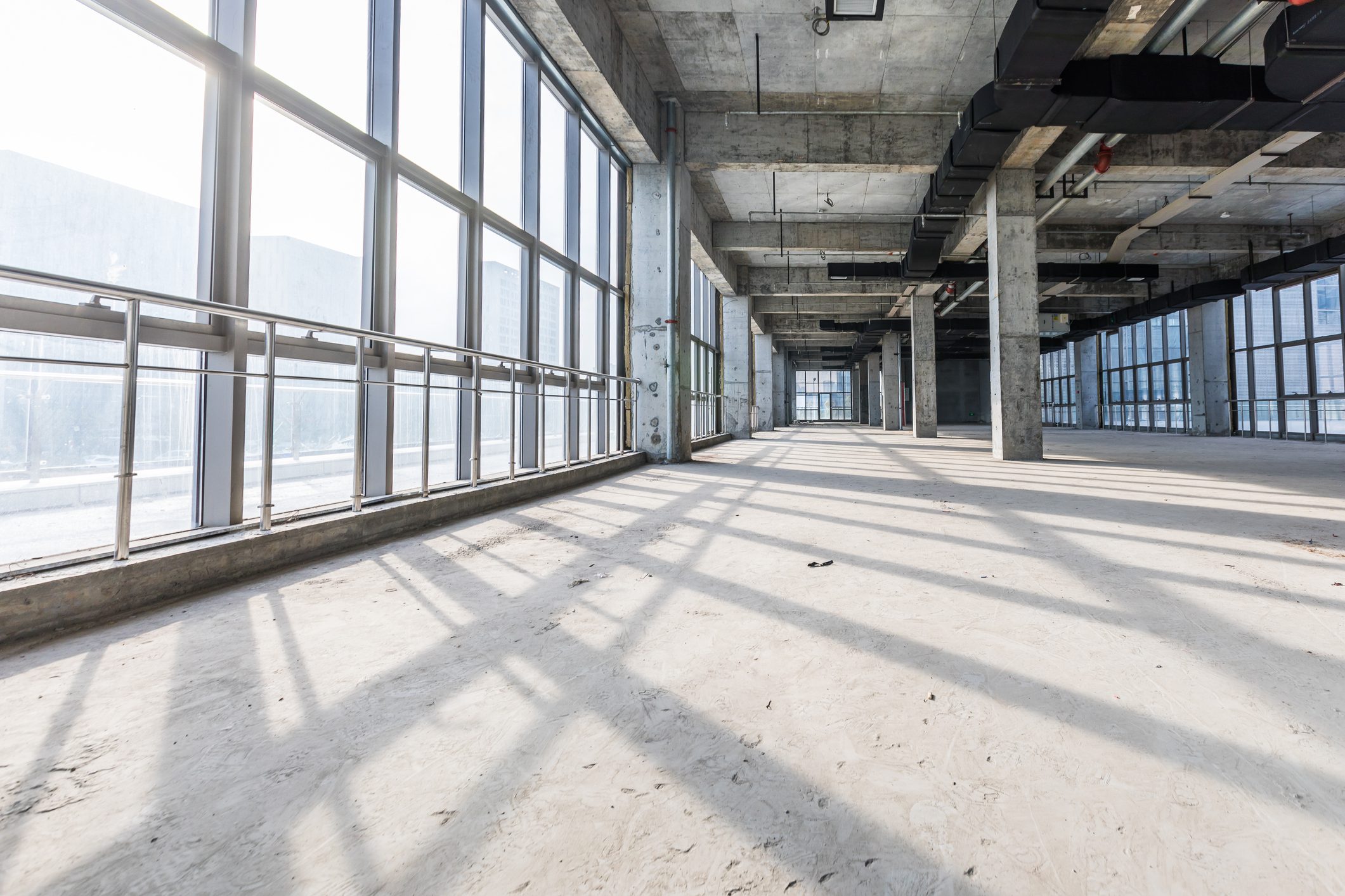 Spacious unfinished interior with concrete floors